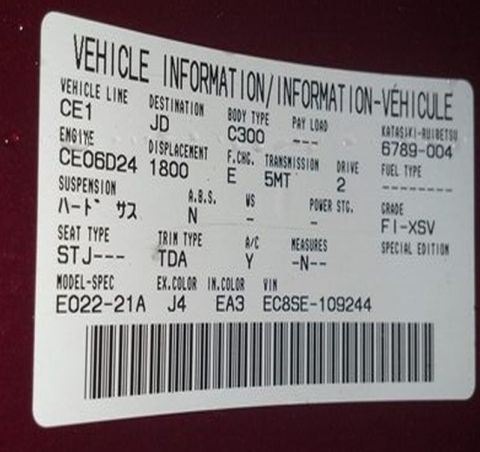 1993 Mazda MX-3 - A vehicle information sticker details specifications like engine, transmission, and grade, with a barcode at the bottom.