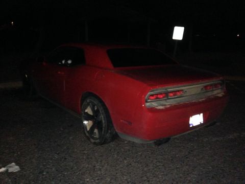 2010 Dodge Challenger - Rear view of a red Dodge Challenger, likely from the 2008-2014 generation.