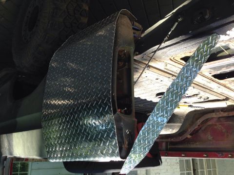 1979 Ford Bronco - Custom diamond plate fender flare is attached to the vehicle's bodywork.