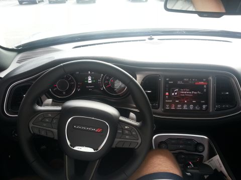 2015 Dodge Challenger - The interior of a 2015 Dodge Challenger features a large infotainment screen and digital instrument cluster.