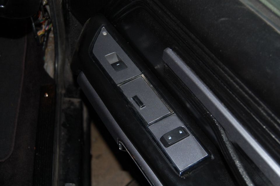 Interior door panel with window and lock controls
