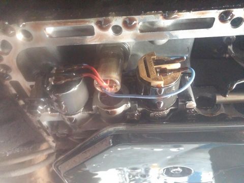 2000 Mercury Grand Marquis - Close-up view of transmission solenoids, showing electrical connections and oily residue.