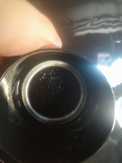 2000 Mercury Grand Marquis - A close-up view of an oil filter shows dark fluid and small particles within its housing.