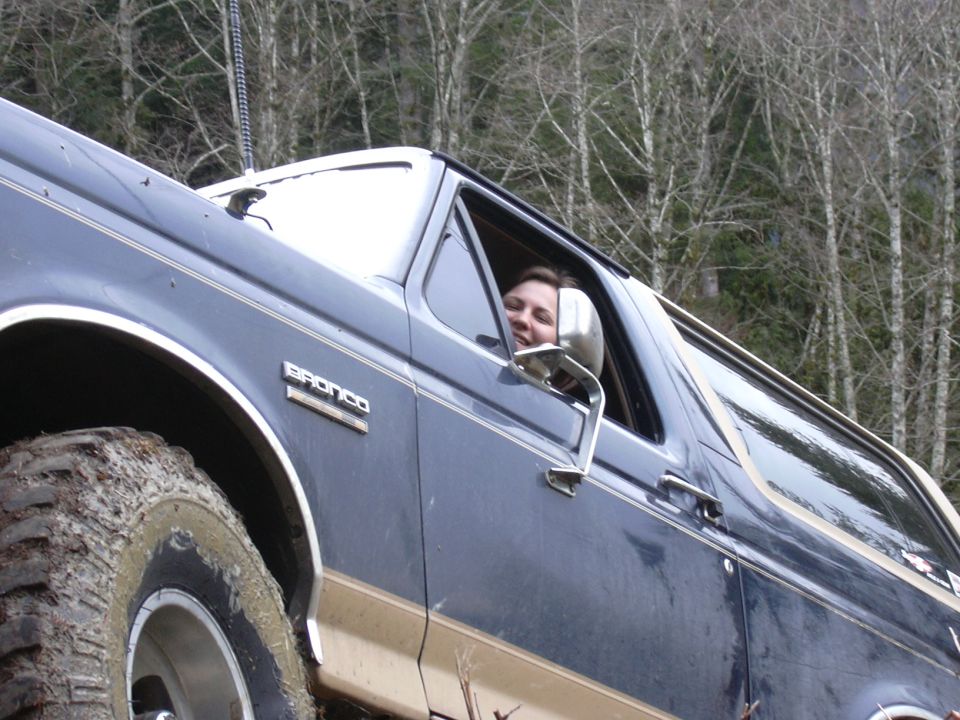 Dark blue 1991 Ford Bronco with a person in the driver's seat