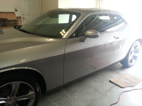 2015 Dodge Challenger - This silver 2015 Dodge Challenger coupe is shown from a 3/4 front angle, parked indoors.