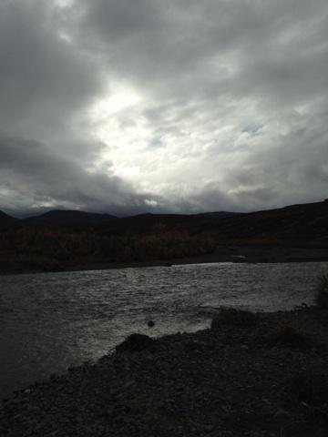 1990 Ford F-250 - A wide shot of a river and its surroundings under a cloudy sky.