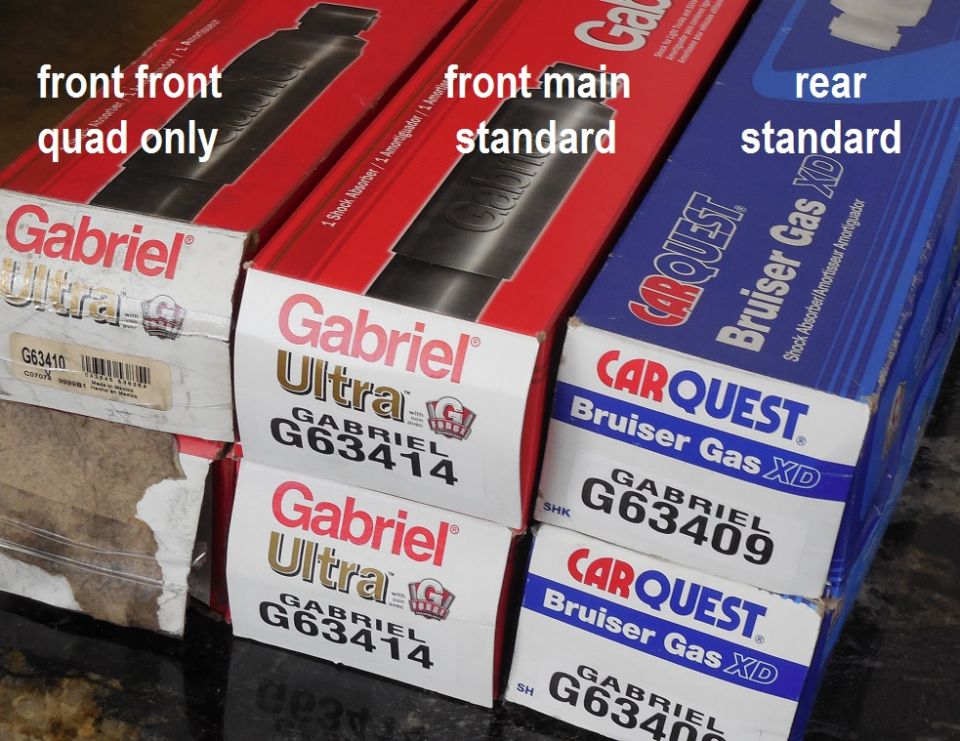 Boxed Gabriel Ultra and Carquest Bruiser Gas XD shock absorbers with labels for front and rear positions.