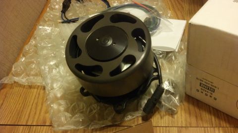 2003 Ford Crown Victoria - black vented electric water pump motor with wiring leads rests on bubble wrap next to a U-Line shipping box.