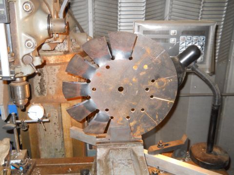 1992 Ford Bronco - A metal fan blade is being worked on by machinery in a workshop.
