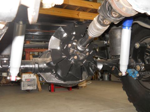 1992 Ford Bronco - Close-up of vehicle undercarriage components including differential, shocks, and driveshaft.