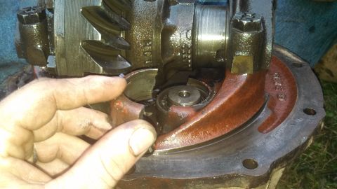 1979 Ford Bronco - Differential gear assembly with a broken component being held by a hand.