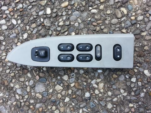 2004 Ford Crown Victoria - This is a car door control panel with buttons for windows, mirrors, and locks.