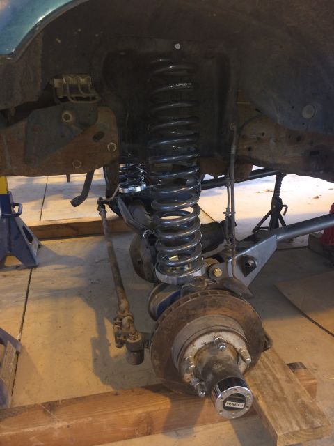 1996 Ford Bronco - Close-up of a vehicle's front suspension and brake components, likely during maintenance.