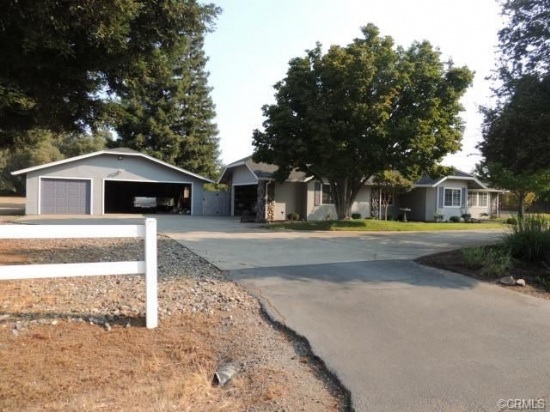 House with attached garage and detached garage. Driveway in front