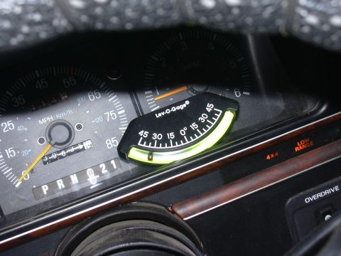 1991 Ford Bronco - Dashboard interior showing speedometer, tachometer, and an aftermarket inclinometer.