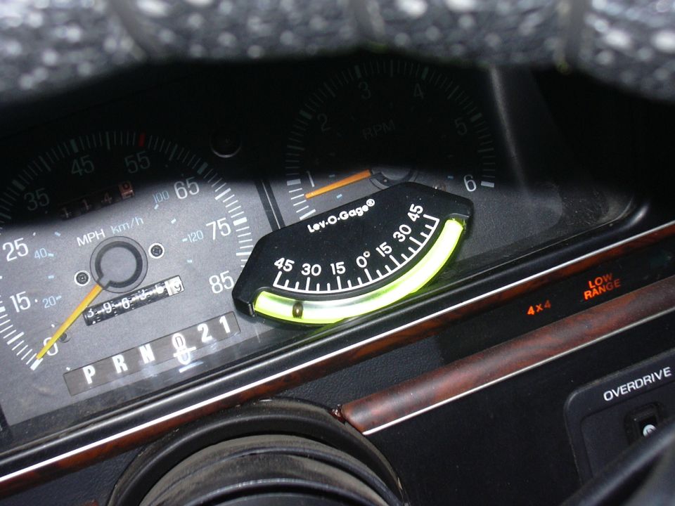 Dashboard interior with speedometer, tachometer, and a Lev-O-Gage inclinometer
