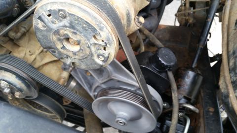 1988 Ford Bronco - Close-up view of engine components including pulleys, belts, and a power steering pump.