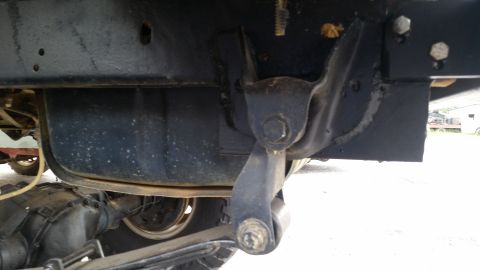1988 Ford Bronco - Close-up of the undercarriage, focusing on suspension parts and the fuel tank.