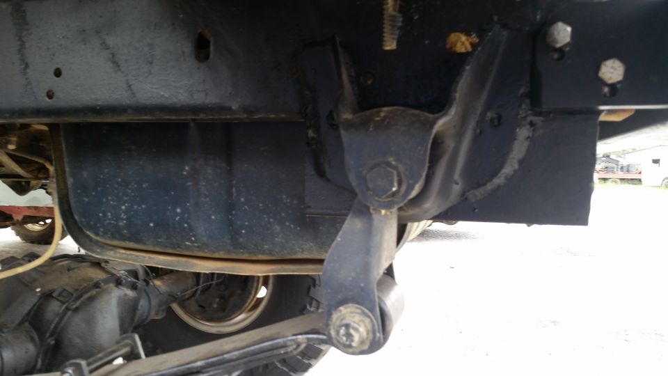 Undercarriage view of vehicle suspension and fuel tank