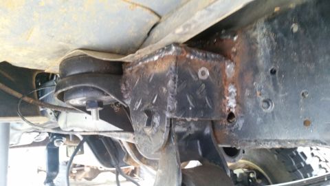 1988 Ford Bronco - Custom suspension mount fabricated onto the vehicle frame with visible welding and bolts.