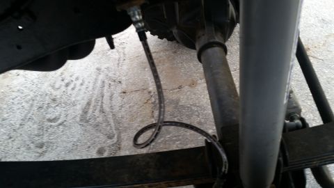 1988 Ford Bronco - Close-up view of a vehicle's rear axle and suspension system.