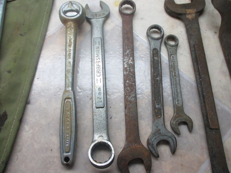 Assorted wrenches and a green tool bag