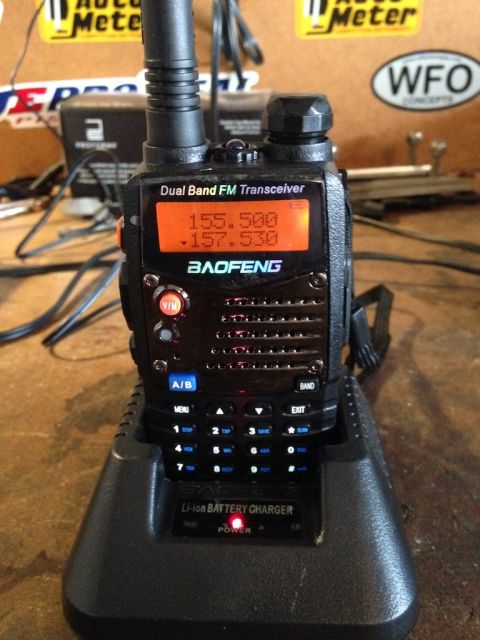 1987 Suzuki Samurai - A Baofeng dual band FM transceiver is shown in its charging base, with frequencies displayed on the screen.