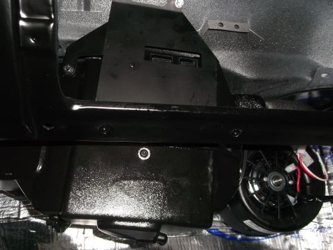 1967 Ford Mustang - Underside view of a vehicle, revealing various mechanical parts and insulation.
