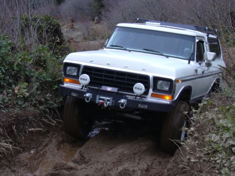 1991 Ford Bronco - This classic Ford Bronco navigates a challenging muddy terrain, its off-road capabilities.
