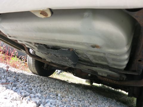 1991 Ford LTD Crown Victoria - The underside of a vehicle, focusing on the fuel tank and surrounding components.