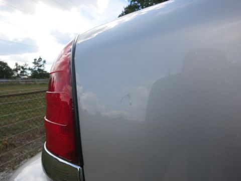 1991 Ford LTD Crown Victoria - Close-up of the rear quarter panel and taillight assembly on a 1991 Ford Crown Victoria LTD.