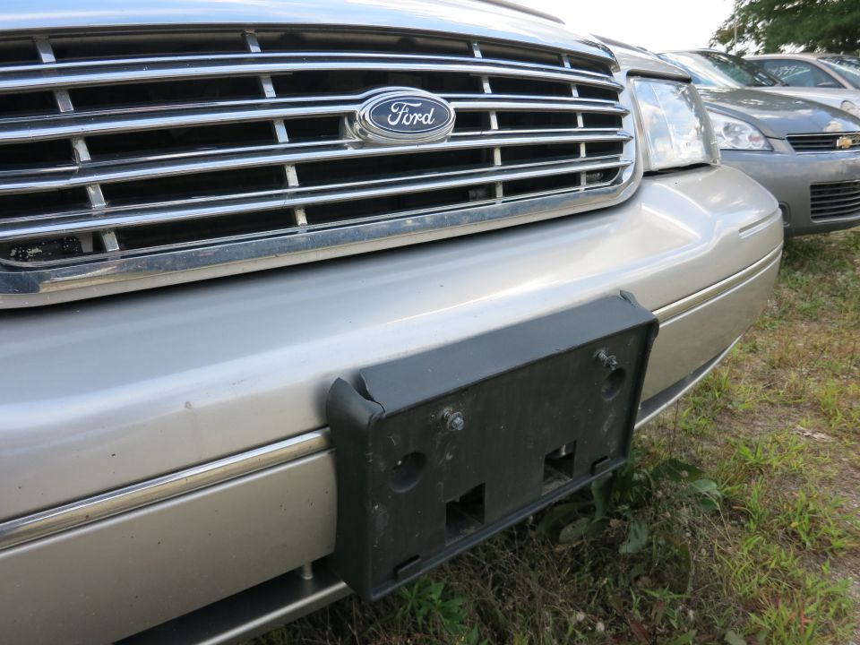 Silver Ford Crown Victoria front grille with Ford badge and license plate bracket