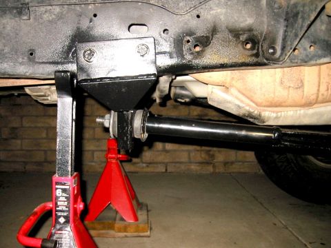 1985 Ford Bronco - Vehicle frame and suspension part shown on jack stands, with Supermotors.net watermark.