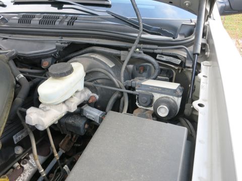 1991 Ford LTD Crown Victoria - Close-up of the engine bay, focusing on the brake fluid reservoir and ABS module.
