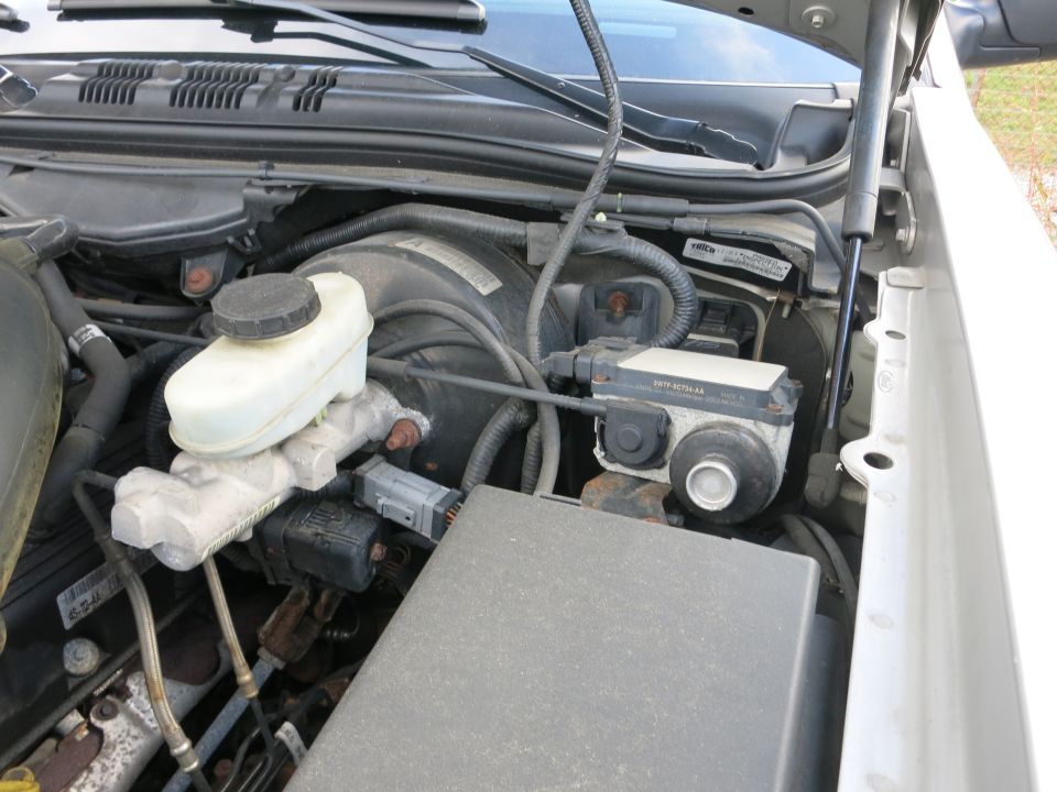 Engine bay showing brake fluid reservoir and ABS module