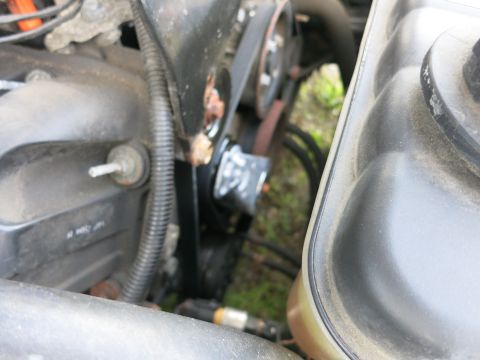 1991 Ford LTD Crown Victoria - Engine bay detail showing a belt and pulley assembly, with a coolant reservoir in the foreground.