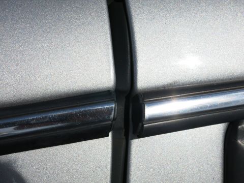 1991 Ford LTD Crown Victoria - Detail shot of the chrome trim and body panel seam on a silver vehicle.