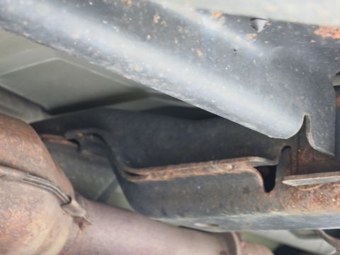 1991 Ford LTD Crown Victoria - Close-up view of the undercarriage of a vehicle, showing chassis components and exhaust piping.