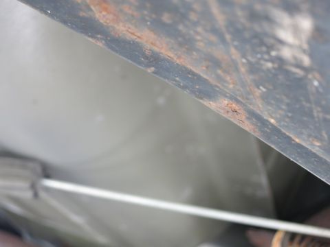 1991 Ford LTD Crown Victoria - Close-up view of the underside of a vehicle, showing rust and different textures.