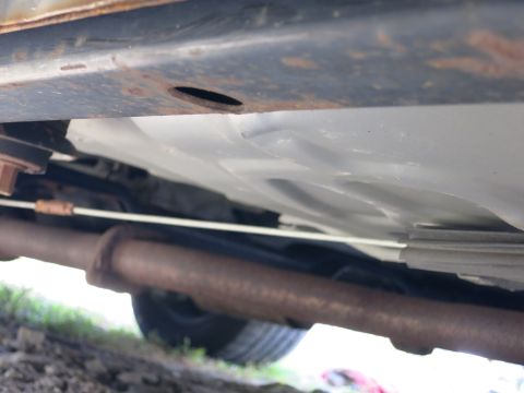 1991 Ford LTD Crown Victoria - Underside view of a car's exhaust system and frame components.