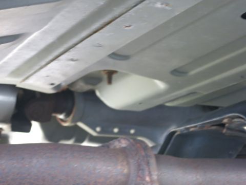 1991 Ford LTD Crown Victoria - Underside view of a vehicle's chassis, focusing on the exhaust system and frame.