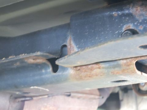 1991 Ford LTD Crown Victoria - Close-up view of rusted metal frame components, showing signs of wear and corrosion.