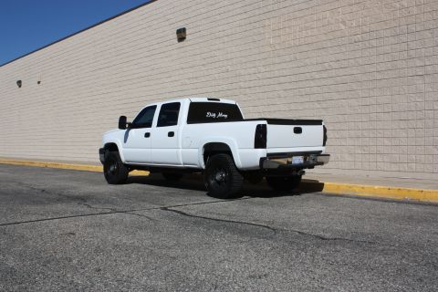 2006 Chevrolet Silverado 2500 - Rear view of a white 2006 Chevrolet Silverado 2500 pickup truck with tinted rear windows.