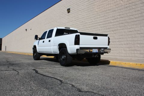 2006 Chevrolet Silverado 2500 - Rear view of a white pickup truck with tinted taillights and a custom license plate.