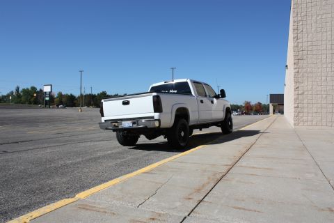 2006 Chevrolet Silverado 2500 - White 2006 Chevrolet Silverado 2500 pickup truck seen from the rear in a parking lot.