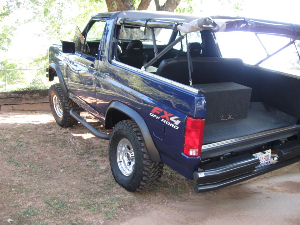 Blue 1982 Ford Bronco with FX4 Off Road decal, rear 3/4 view