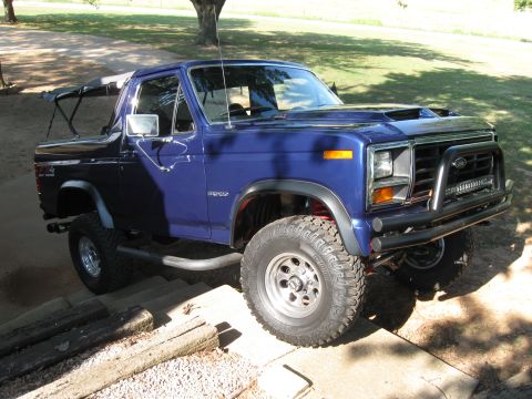 1982 Ford Bronco - This lifted 1982 Ford Bronco features a custom front bumper and hood scoop, giving it a appearance.