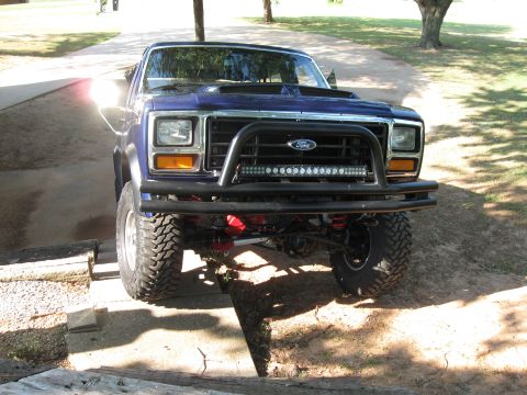 1982 Ford Bronco - This modified Ford truck is equipped with a custom front bumper and auxiliary lighting, ready for off-road adventures.