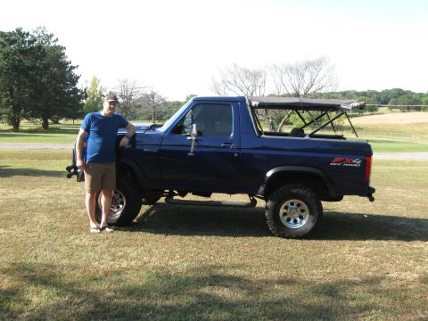 1982 Ford Bronco - Man poses with his blue 1982 Ford Bronco, which features an FX4 Off Road decal.