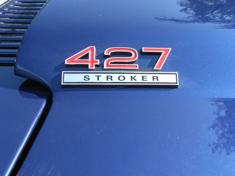1982 Ford Bronco - Close-up of a blue vehicle's hood a '427 Stroker' emblem.
